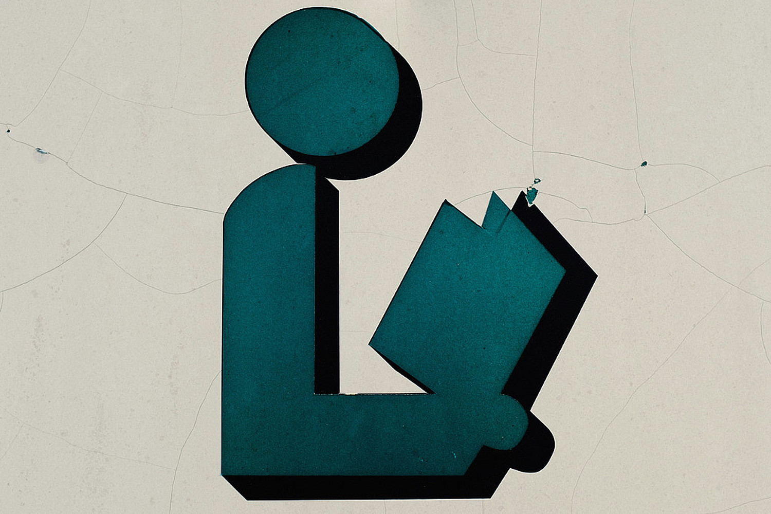 Figur liest in einem Buch - Symbolbild